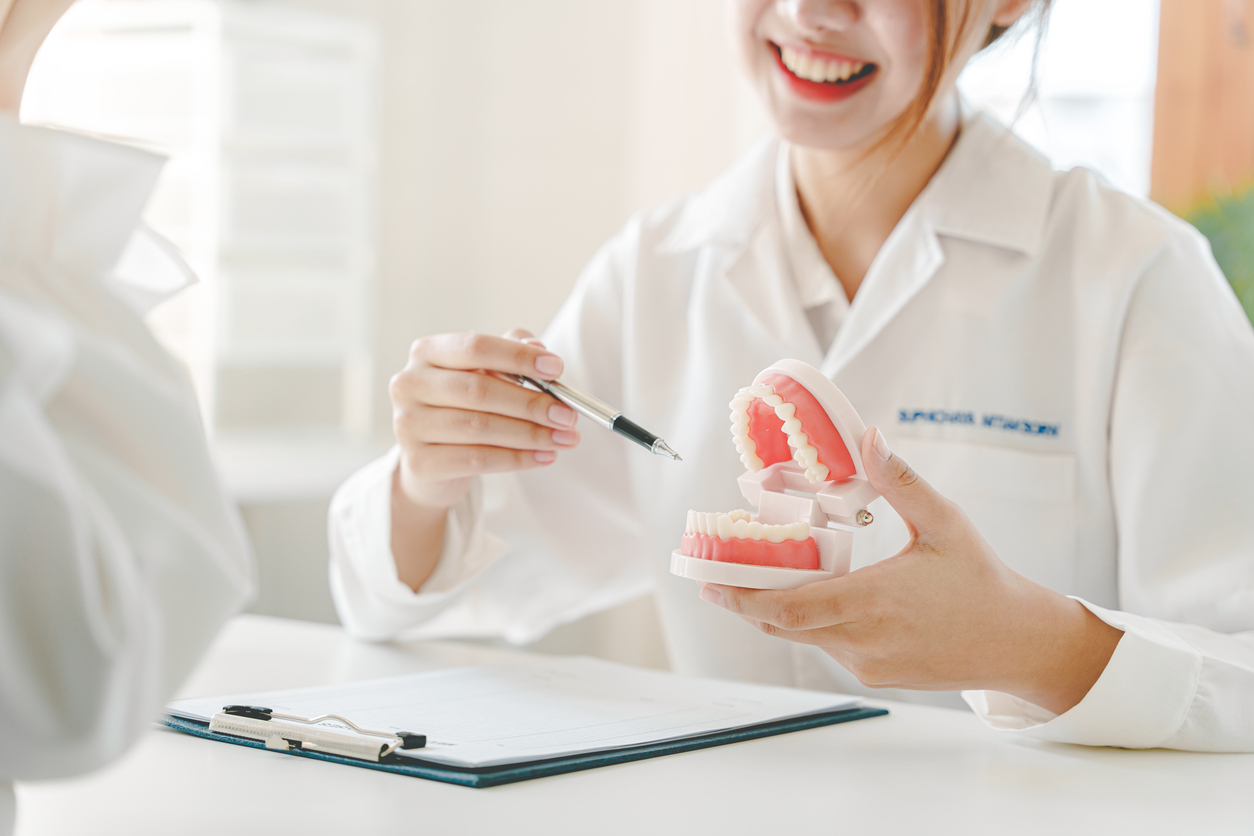 a female dentist recommending dental care methods in her dentist's office