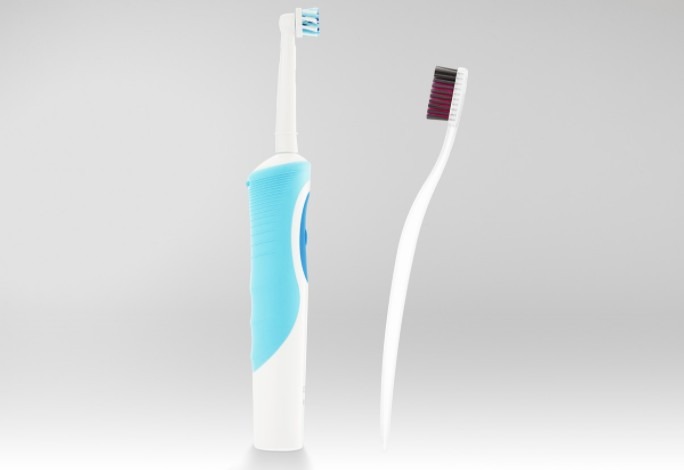 A battery operated toothbrush and a manual toothbrush