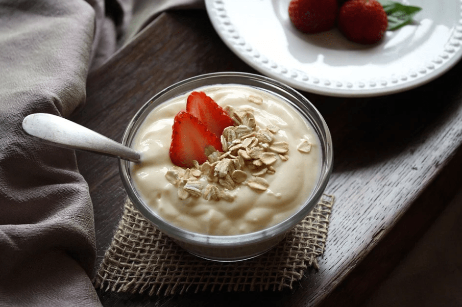 a bowl of yogurt with oatmeal and strawberries