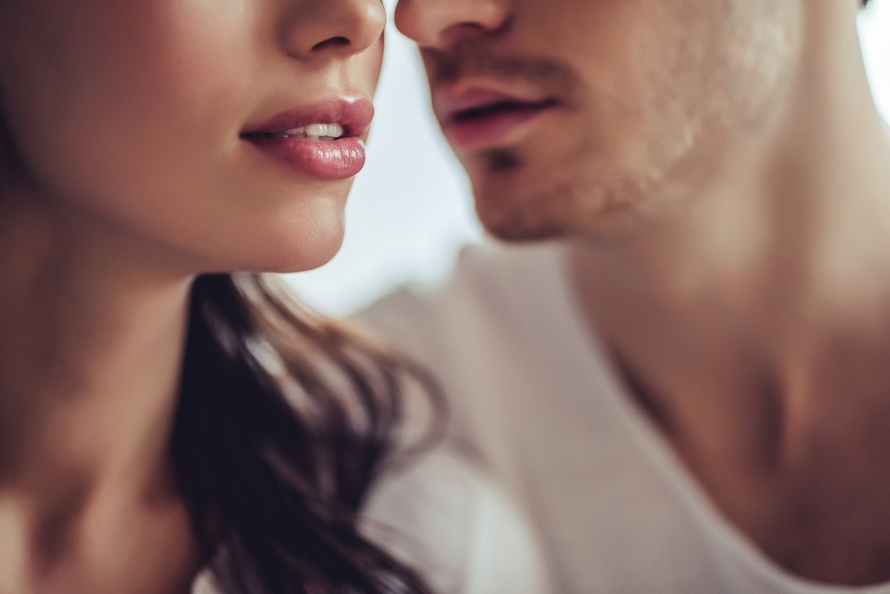 Cropped image of beautiful young couple. Close up of two lovers are going to kiss.