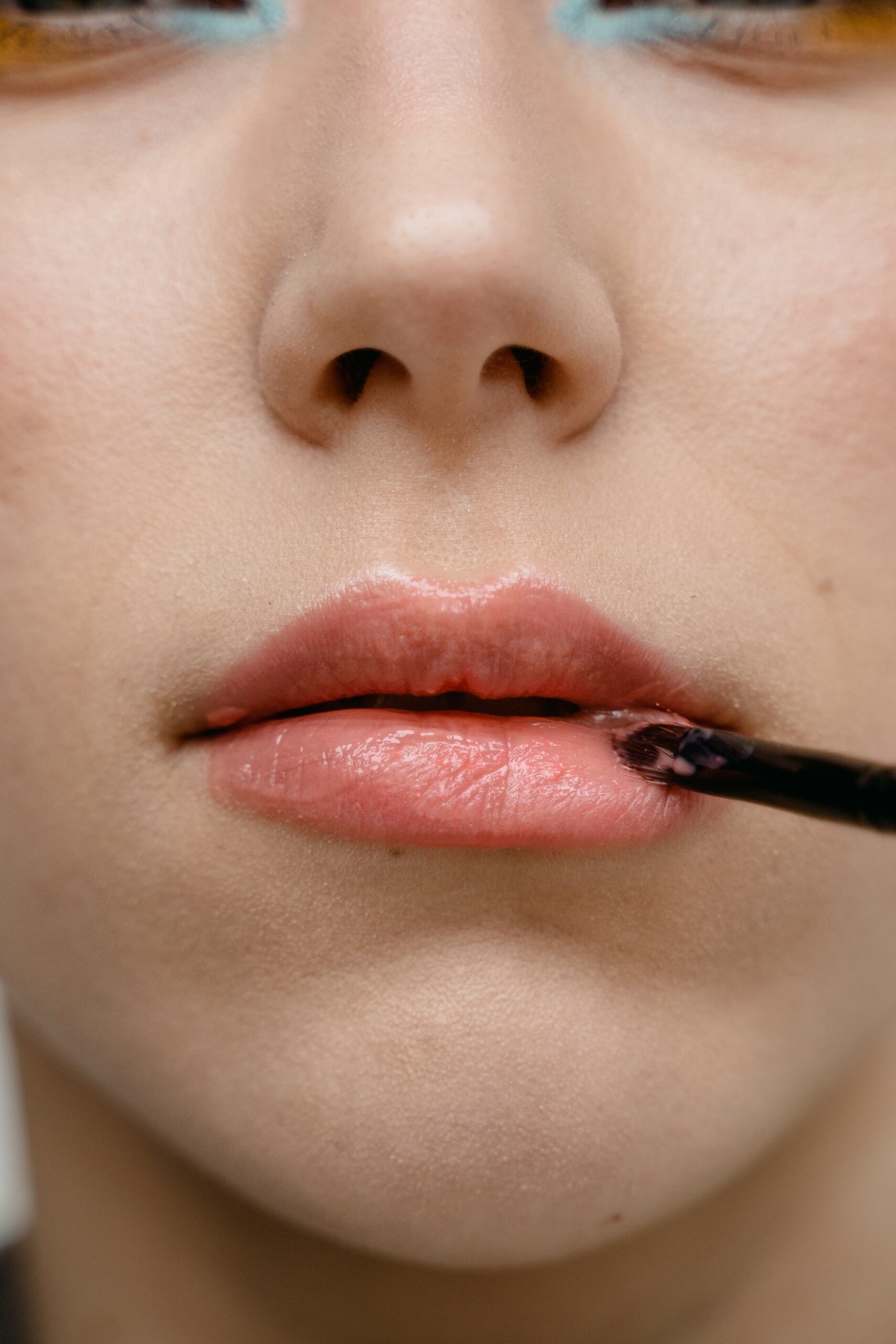 a-close-up-shot-of-a-person-applying-lipstick