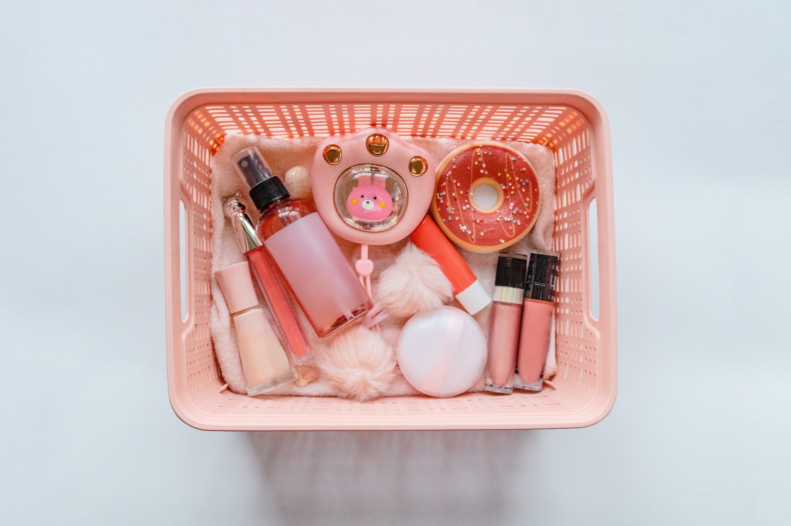 collection-of-cosmetic-products-in-a-pink-storage-bin
